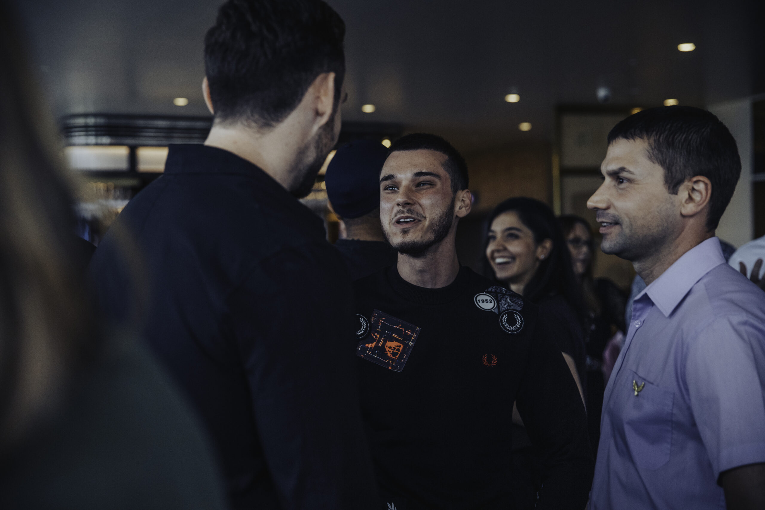 Group of diverse professionals networking and smiling at a London meetup event in August 2021, fostering connections.