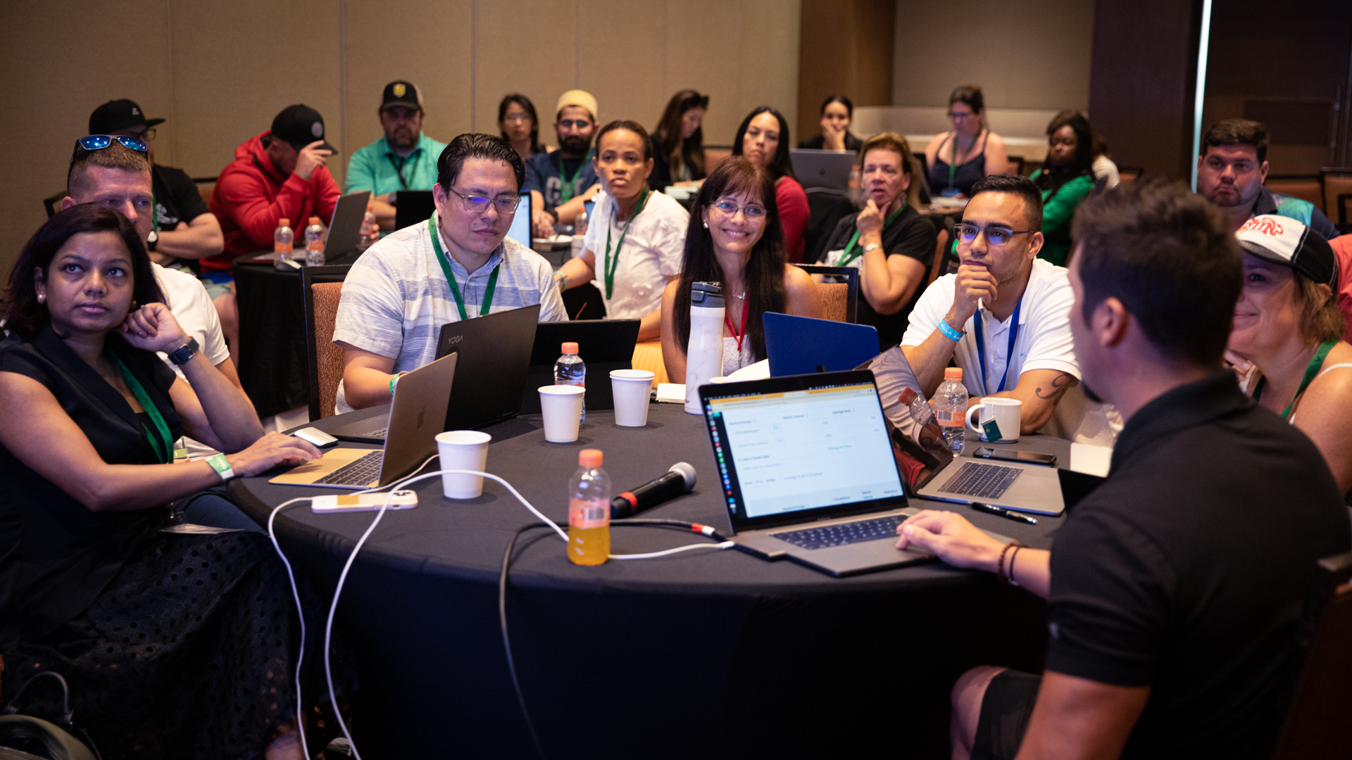 Diverse group collaborating around a roundtable, fostering innovation and connection in a mastermind community setting.