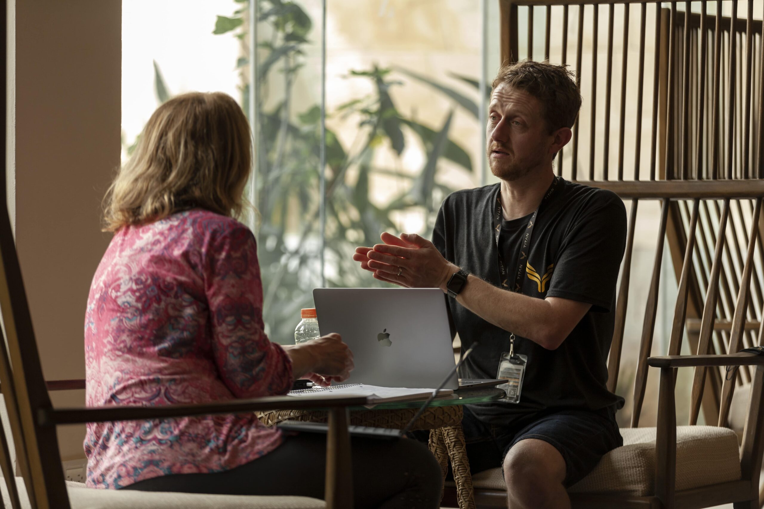 Professional coaching session with mentor guiding client for personal growth and success in a modern office setting.